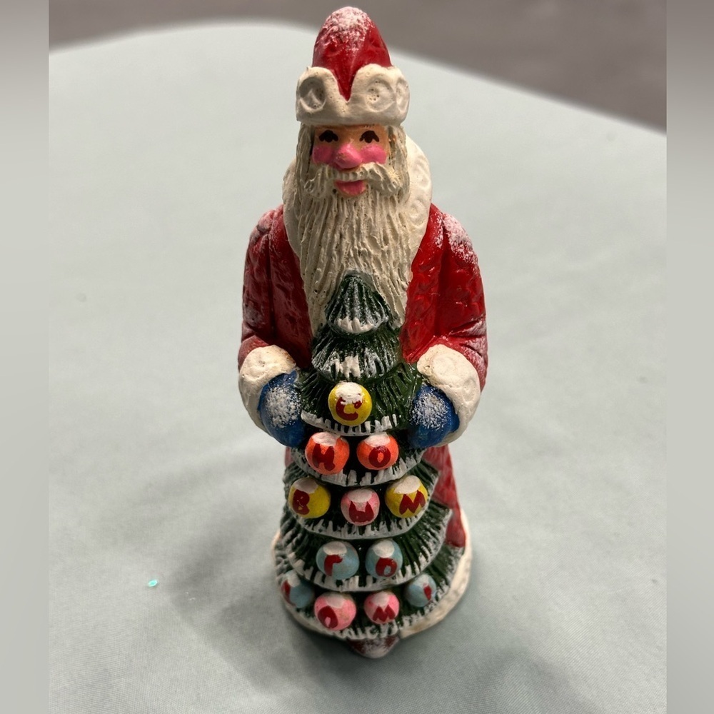 Resin Santa figure carries a special greeting
